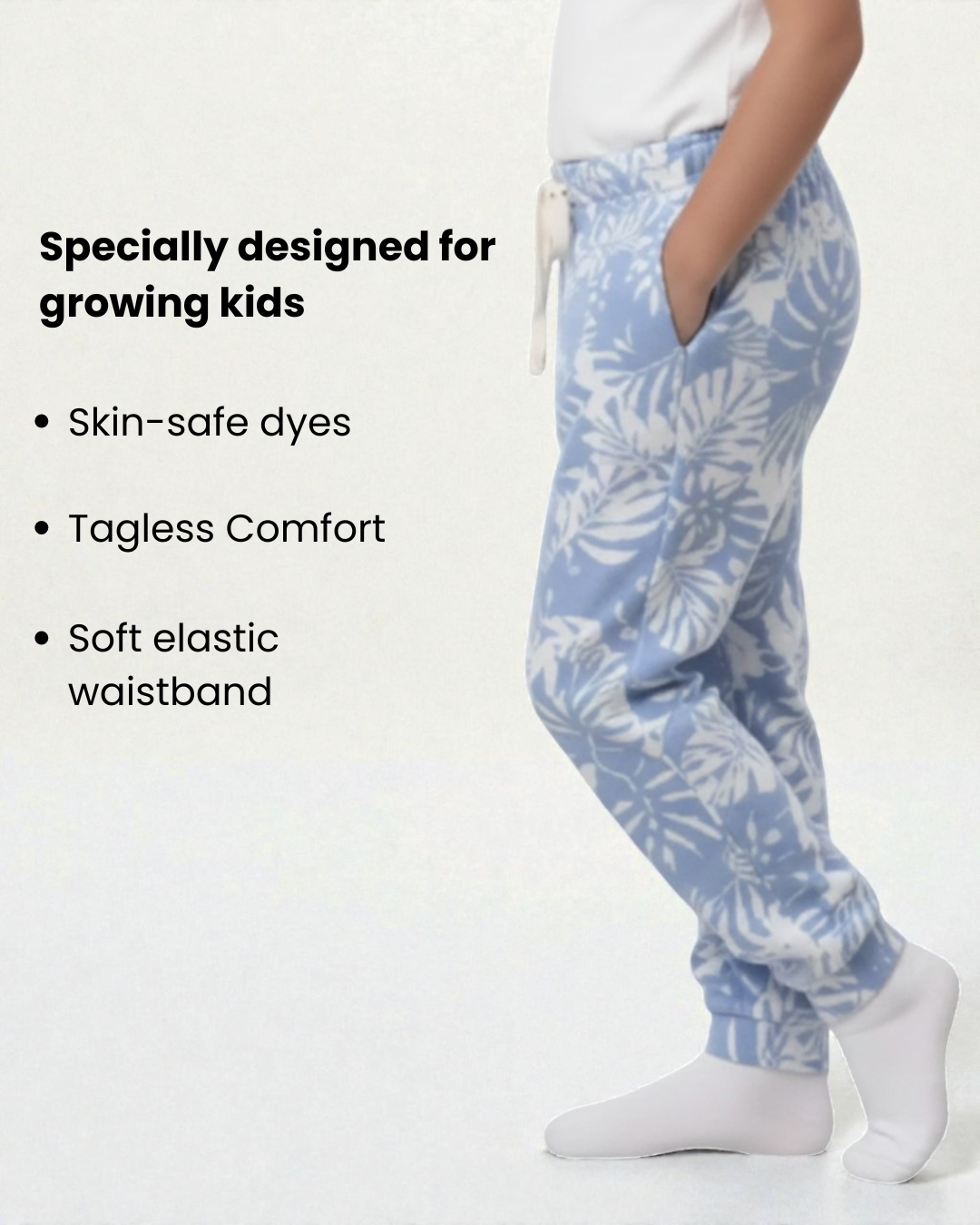 Girl side view wearing pure cotton blue and white flower print pyjama kids sleepwear FNS India with text about product features.