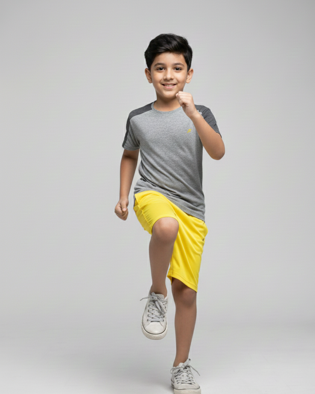 Boy's wearing a gray t-shirt  on a plain background