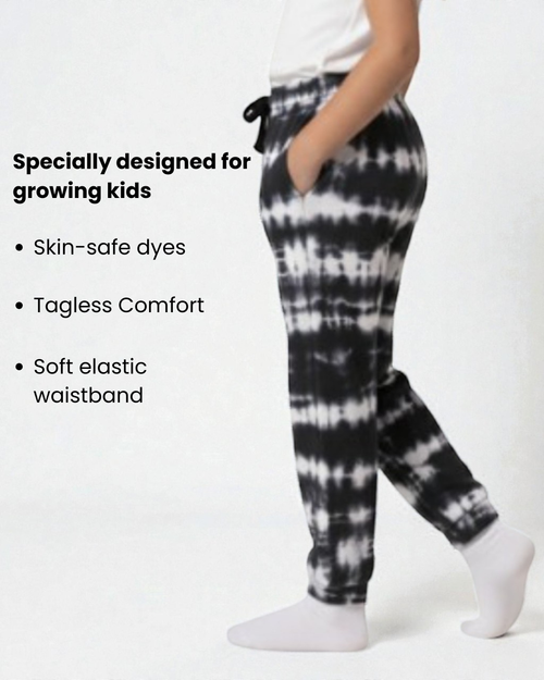 Girl side view wearing pure cotton black and white tie-dye pyjama kids sleepwear FNS India with text about product features.