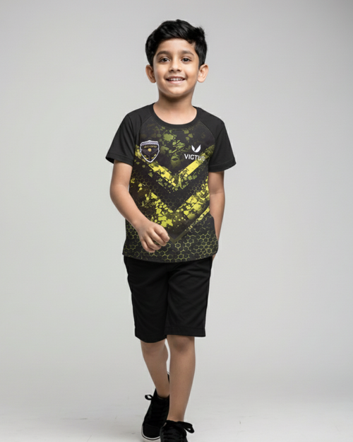 Front View of Boy's wearing a black t-shirt with yellow graphics and black shorts on a gray background