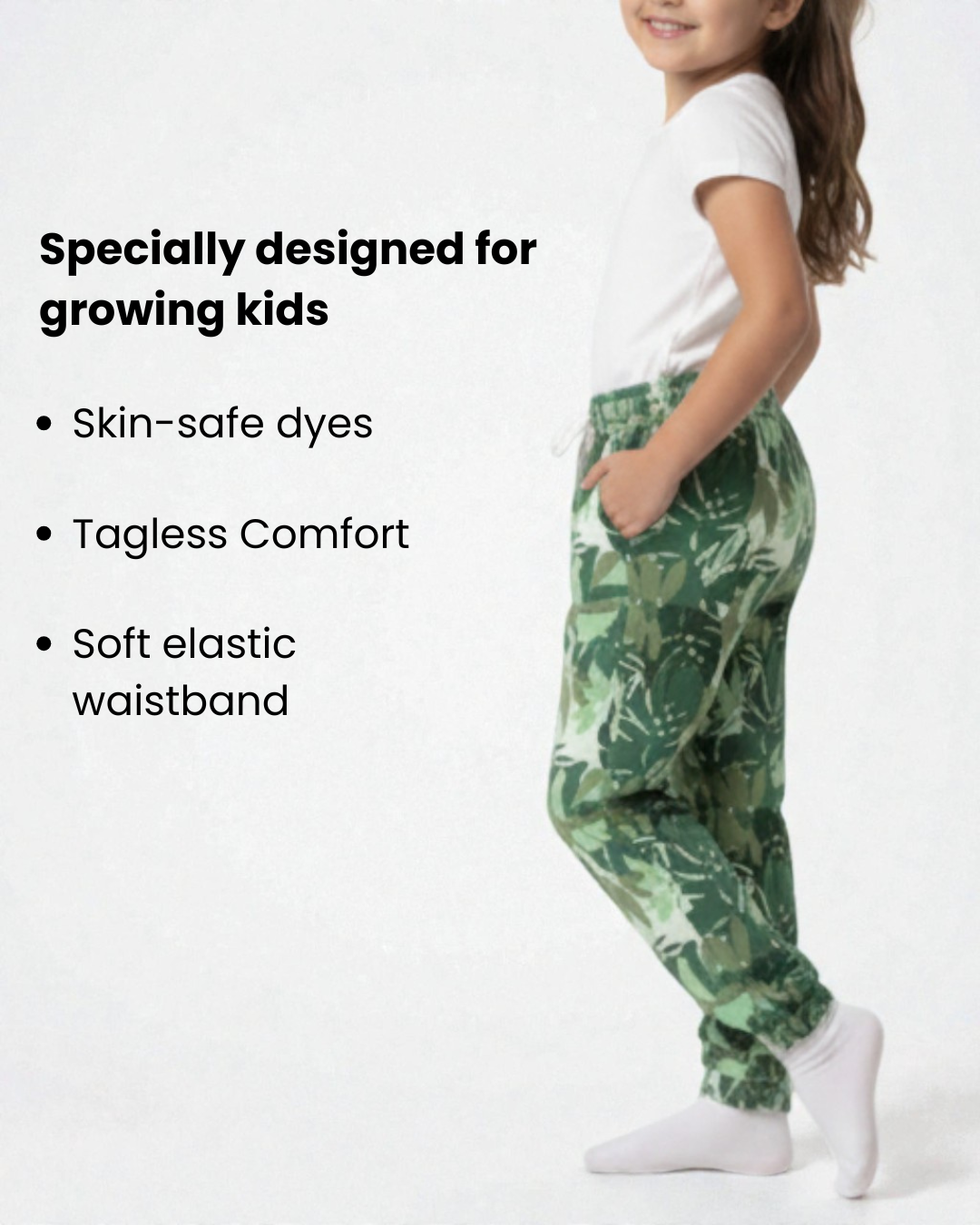 Girl side view wearing pure cotton green camouflage print pyjama kids sleepwear FNS India with text highlighting features on a white background.